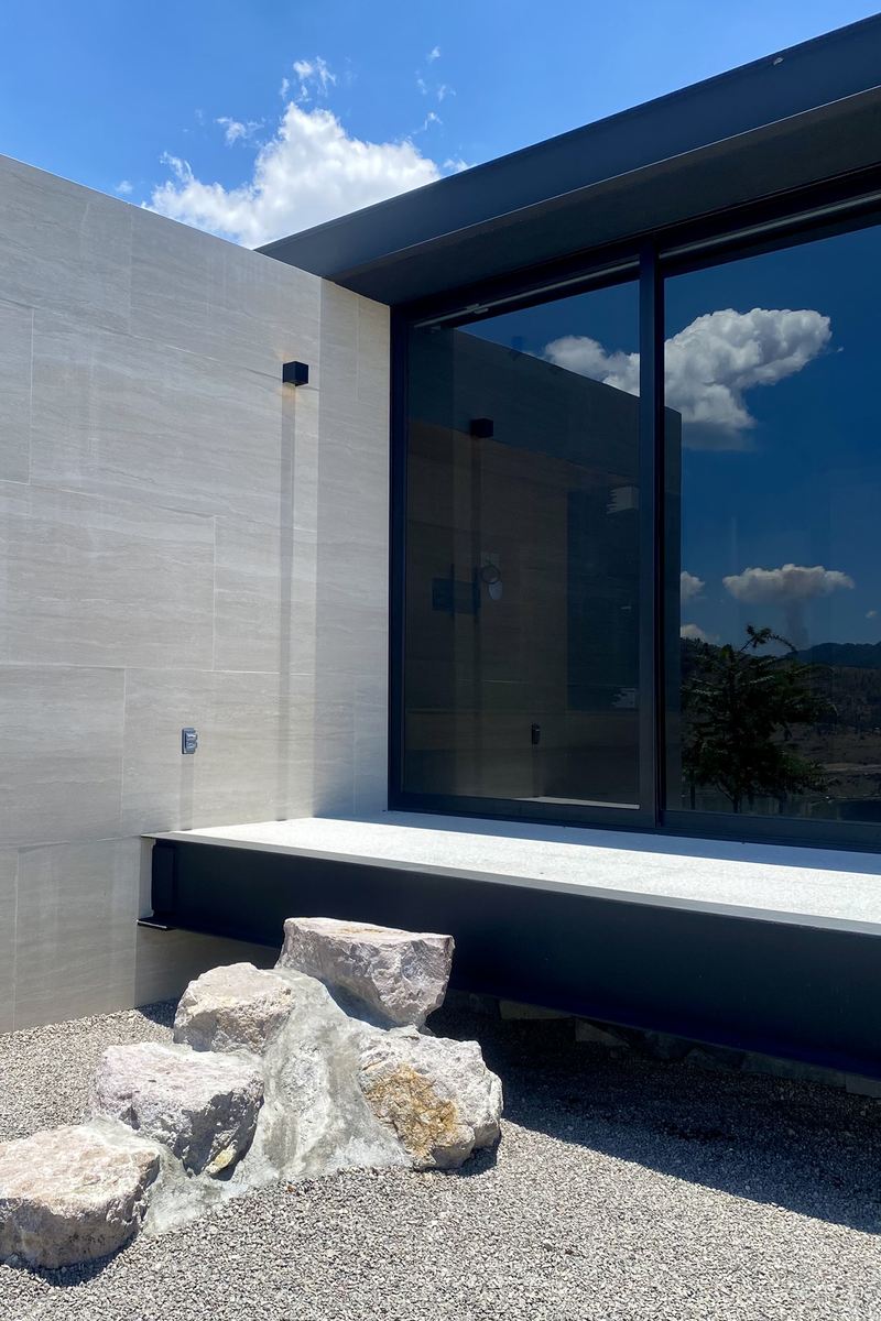 Casa PT24 — terraza mineral y roca
